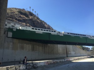 A Metrolink train passes by the LA River confluence.